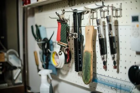 Leather craftsman threads and tools for leather works collected on shelf Stock Photos
