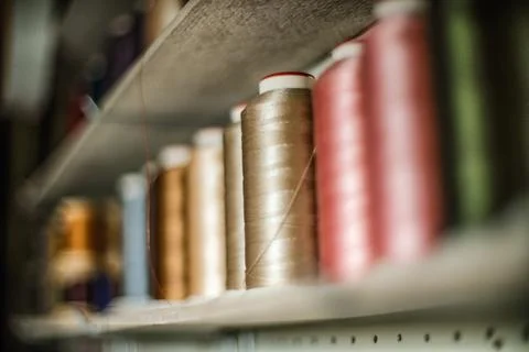 Leather craftsman threads and tools for leather works collected on shelf Stock Photos