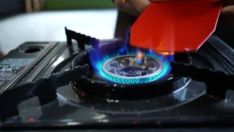 Leather edge searing over portable gas burner in closeup workshop scene Stock Footage 312258803