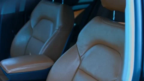 Leather front seats in car. Beautiful leather car interior design. Car details Stock Footage 143800076