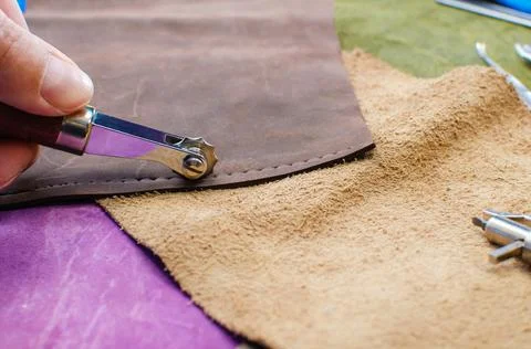Leather goods manufacturing process. Tools for sewing bags, wallets, clutches Stock Photos