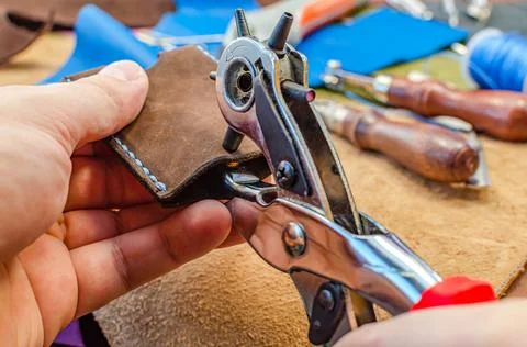 Leather goods manufacturing process. Tools for sewing bags, wallets, clutches Stock Photos