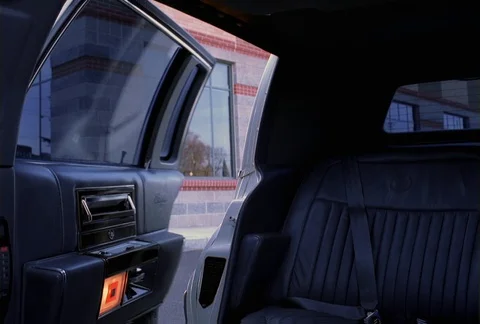 The leather interior of a limousine is seen as the door opens to a Stock Footage 86773565