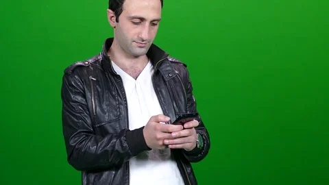 Leather Jacket Man Sending a Text Green Screen 動画素材 83734726
