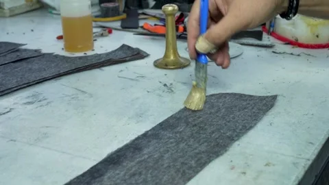 Leather Jacket Production – Worker Applying Adhesive with Brush in Workshop Stock Footage 322057795