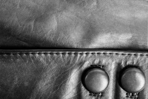 Leather jacket seam with buttons texture. Stock Photos