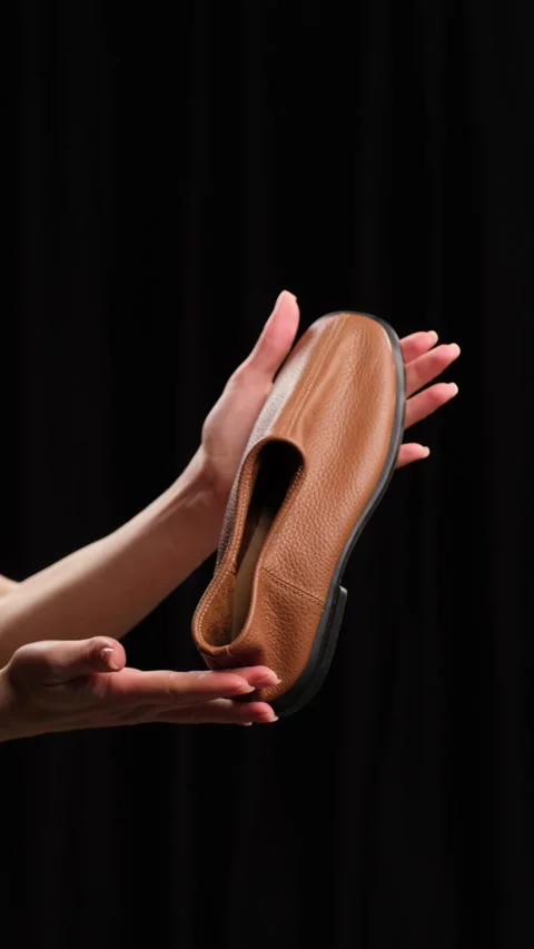 Leather Loafer Flexibility Test on black background Stock Footage 303774493