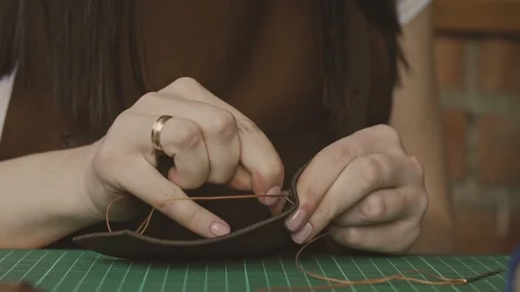 Leather master sewing with needle and strings. Skinner working with leather Video stock 116432729