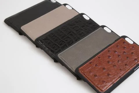 Leather phone case craftsmanship work on the white background. Stock Photos