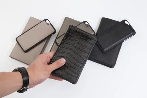 Leather phone case craftsmanship work on the white background. Stock Photos