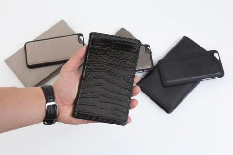 Leather phone case craftsmanship work on the white background. Stock Photos