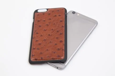 Leather phone case craftsmanship work on the white background. Stock Photos