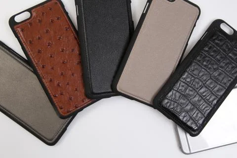 Leather phone case craftsmanship work on the white background. Stock Photos