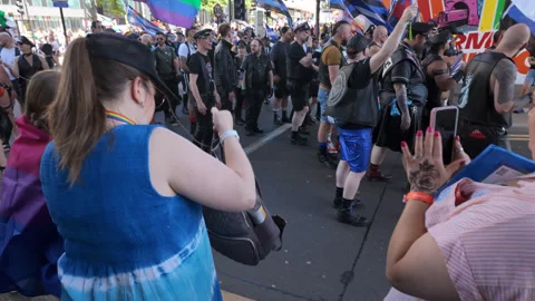Leather Pride group marching in parade and waving community specific pride flags Stock Footage 335827453