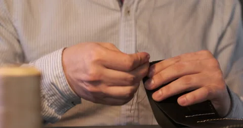 Leather Sewing Process Details. Mans Hands with Needle and Strings Making Wallet Stock Footage 148199505