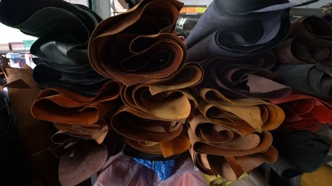 Leather shop with various bundle of genuine cow leather craftmanship store Stock Footage 104070473