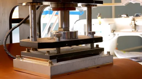 Leather stamp press go up Stockbeeldmateriaal 118135375