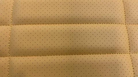 Leather stitched and perforated with pattern, leather orange texture Stock Photos