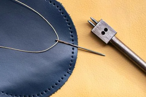 Leather Stitching Needle and Thread on Navy Blue Round Leather Piece with H.. Stock Photos