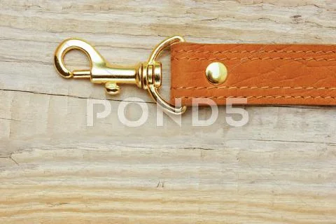 Leather Strap With Carabiner On A Wooden Board