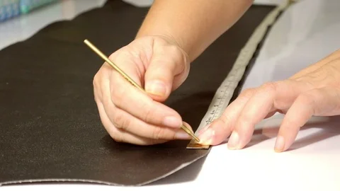 Leather tailor is working with her handmade product Stock Footage 101035496