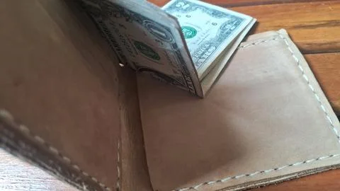 Leather wallet with dollar bills inside. Business finance and cash management Stock Photos