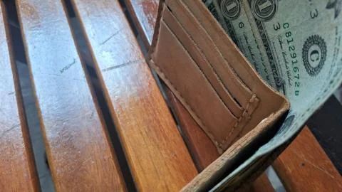Leather wallet with dollar bills inside. Businessman holding cash in wallet, Stock Photos