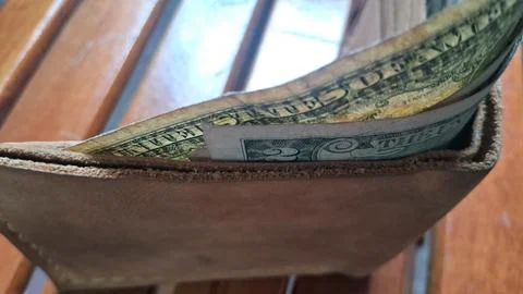 Leather wallet with dollar bills inside. Business and finance concept with cash Stock Photos