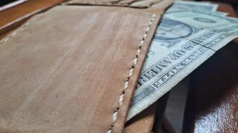 Leather wallet with dollar bills inside. Business finance and cash storage Stock Photos