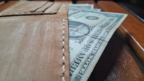 Leather wallet with dollar bills inside. Business and financial concept image. Stock Photos