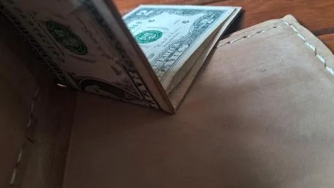 Leather wallet with dollar bills inside. Businessman holding cash for financial Stock Photos