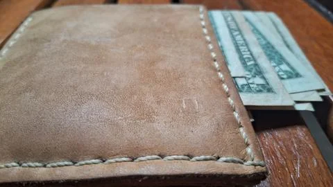 Leather wallet with dollar bills inside. Business and finance concept, money Stock Photos