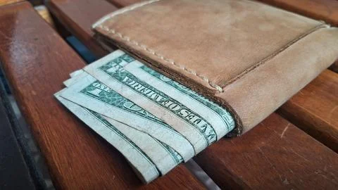 Leather wallet with dollar bills inside. Business and finance concept with cash Stock Photos