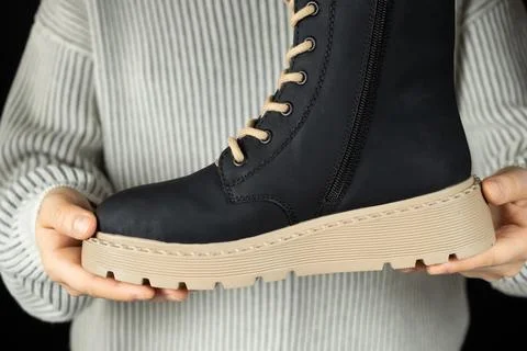 Leather winter boot in hands. High-quality fashionable shoes Stock Photos