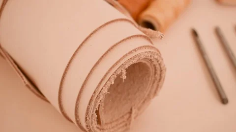 Leather working tools and rolled up hide organized Stock Footage 126115508