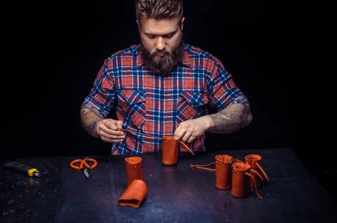 Leather workman forms new leather product at the leather studio Stock Photos