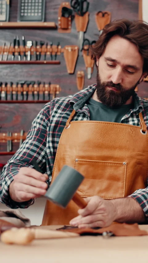 Leather workshop, man and tools with craft, manufacturing and unique textile Stock Footage 332892931