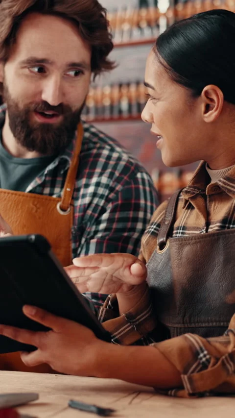 Leather workshop, people and tablet with conversation, planning and tools for Video stock 332892121