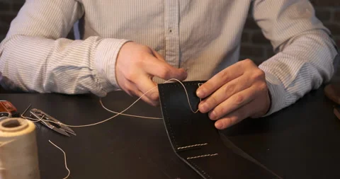 Leather Workshop. Poor Lighting. Twilight. Exact Movement of Master's Hands Stock Footage 148361258