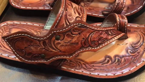 Leathered pattern shoes or sandals made by a Thai craftman Stock Footage 260731247