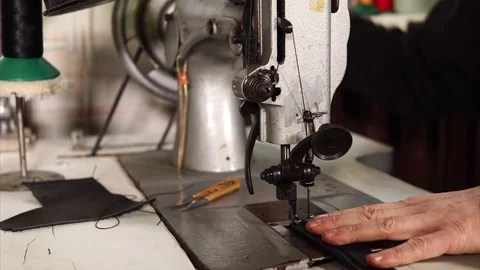 Leatherworker is using sewing machine. Stock Footage 83046639