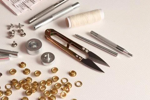 Leatherworking tools and hardware installation on light background Stock Photos