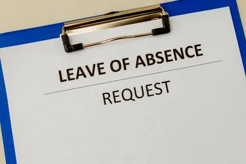Leave of absence request on the tablet at the table. Stock Photos