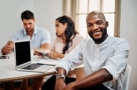 Leave the task up to us. Portrait of a young businessman having a meeting with Stock Photos