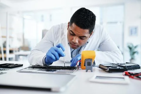 Leave your technical mishaps in his expert hands. a young man repairing computer Stock Photos