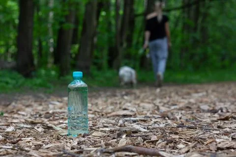 A leaved water bottle on a path Stock Photos
