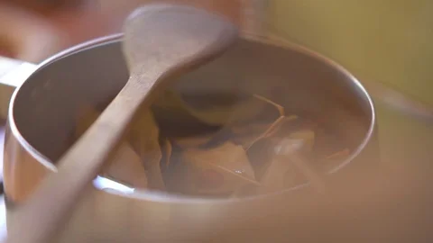 Leaves being cooked in pan at home Stock Footage 76097791