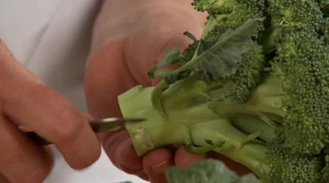 Leaves being removed from broccoli and the florets being cut off Stock Footage 24634577