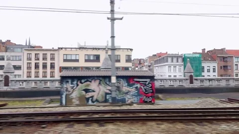 Leaving city of Antwerp by train with view on tracks and houses Stock Footage 169013332