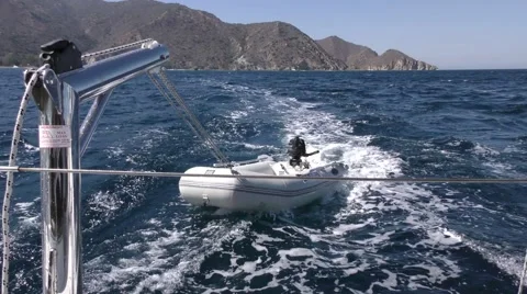 Leaving island a motorized dinghy is getting bashed about in rough seas Stock Footage 68002768